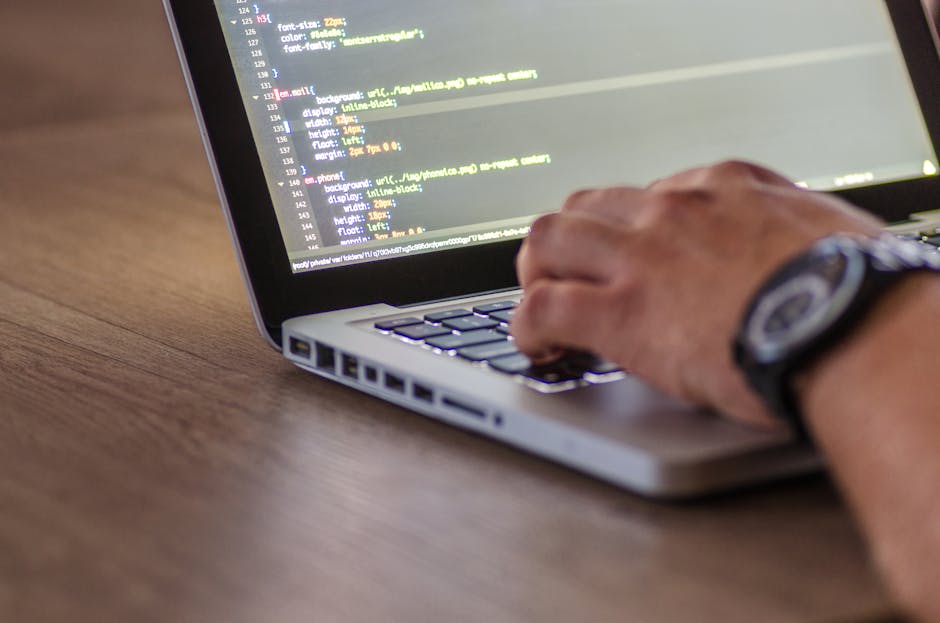 CVSS - A close-up shot of a person coding on a laptop