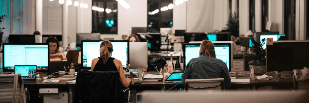 Dell Command Update Deployment, Automation, and Common Pitfalls: office with multiple workers at a shared desk